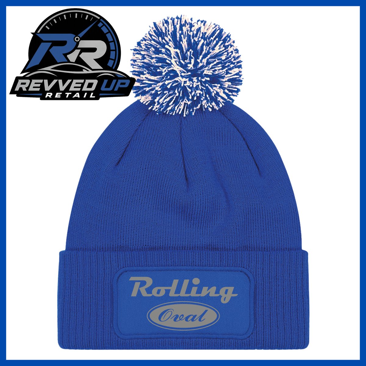 A royal blue knit beanie with a white and blue pom-pom on top and a red cuffed front patch reading 'Rolling Oval' in grey. A Revved Up Retail logo appears in the upper left corner.