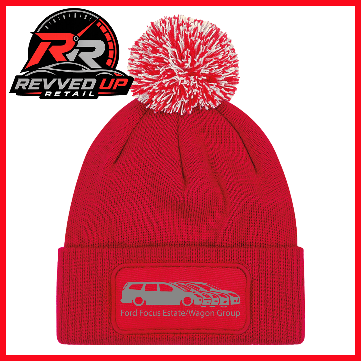 A red knit beanie with a red and white pom-pom on top and a folded cuff featuring a gray patch with a car graphic and the text 'Ford Focus/Estate Wagons Group.' A Revved Up Retail logo appears in the upper left corner.