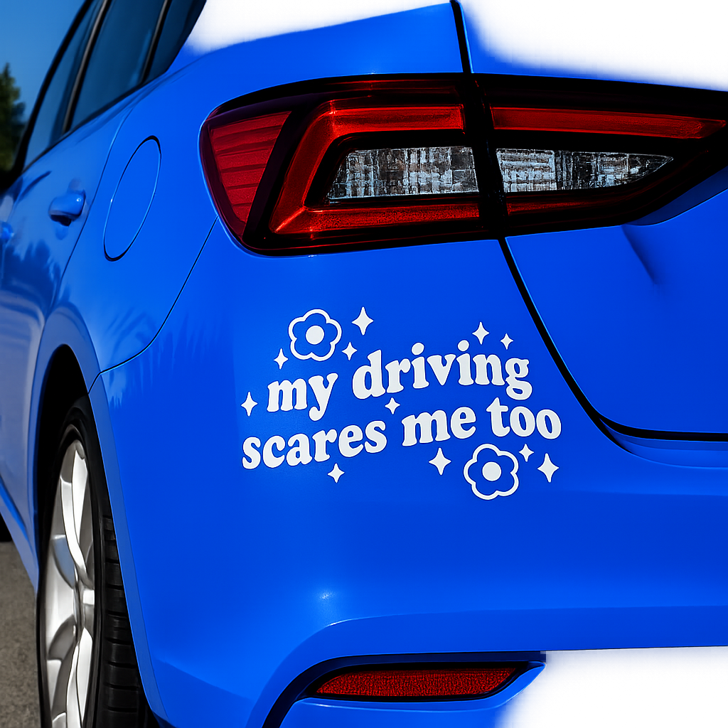 A white vinyl car decal with the text 'my driving scares me too' and small flower and star graphics, shown applied to the rear quarter panel of a bright blue car.