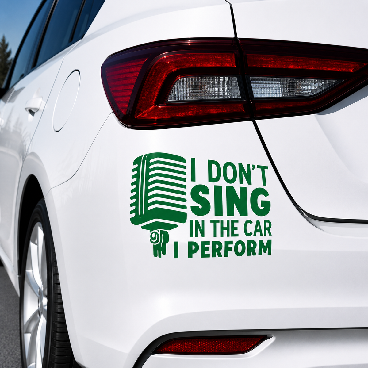 A green retro microphone decal with the text 'I DON'T SING IN THE CAR I PERFORM' applied to the rear quarter panel of a white car.