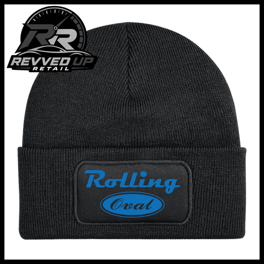 A black ribbed knit beanie with a cuffed brim, featuring a rectangular black patch on the front with the words 'Rolling Oval' in blue. The Revved Up Retail logo is visible in the top-left corner.