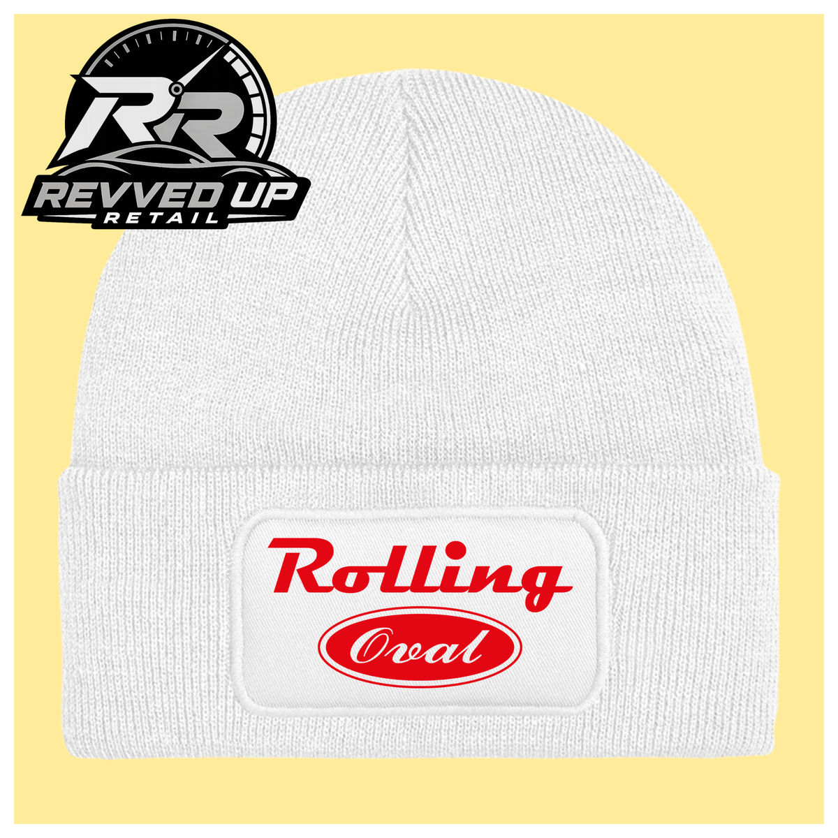 A white ribbed knit beanie with a folded cuff featuring a white patch that reads 'Rolling Oval' in red. The beanie is centered on a pale yellow background, with a Revved Up Retail logo in the top-left corner.