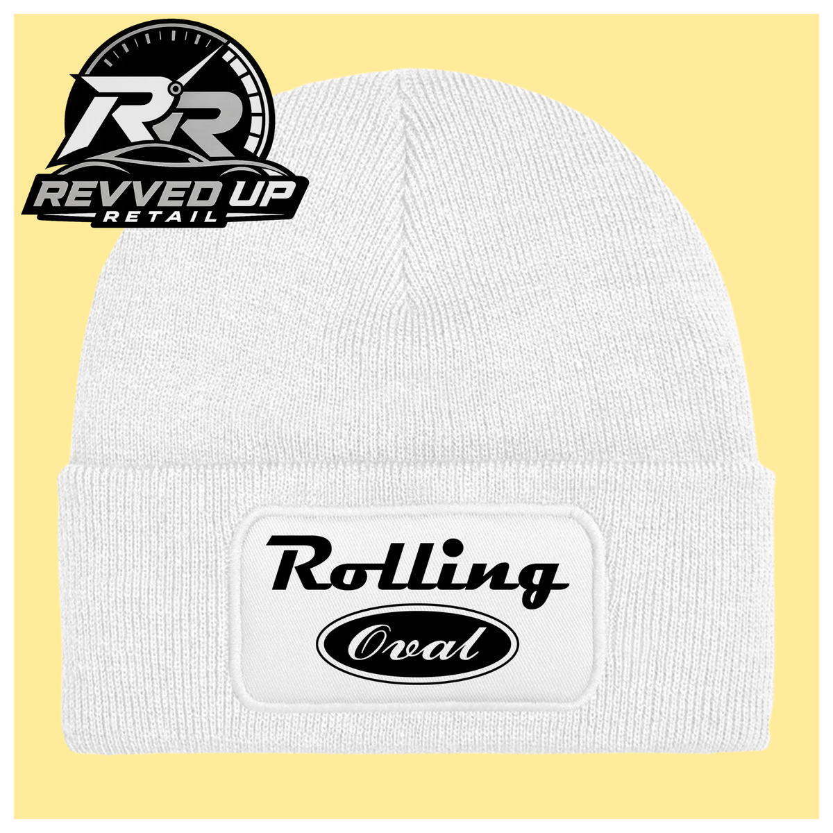A white ribbed knit beanie with a folded cuff featuring a white patch that reads 'Rolling Oval' in black. The beanie is centered on a pale yellow background, with a Revved Up Retail logo overlay in the top-left corner.