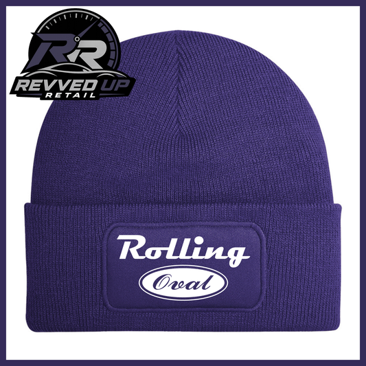 A purple ribbed knit beanie with a cuffed brim featuring an oval patch that reads 'Rolling Oval' in white. A Revved Up Retail logo is visible in the top-left corner.