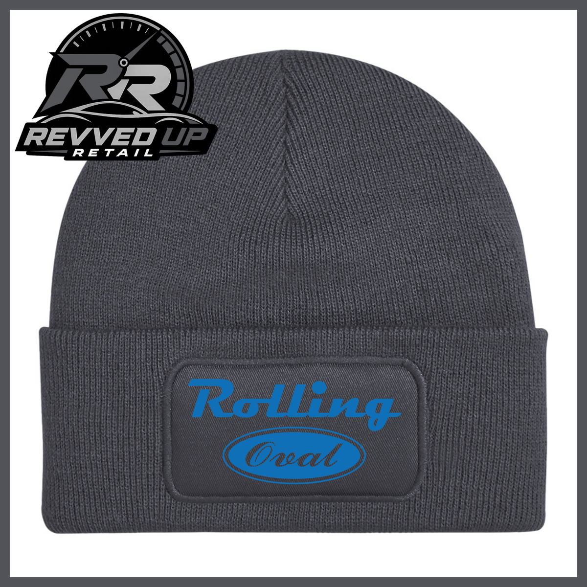 A dark grey ribbed knit beanie with a folded cuff featuring a black patch that reads 'Rolling Oval' in blue. A Revved Up Retail logo is visible in the top-left corner.