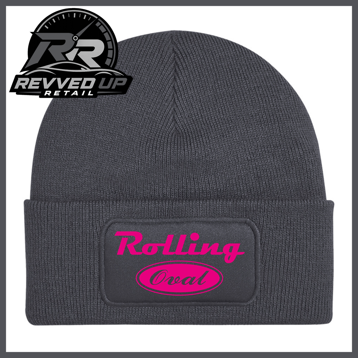 A dark grey ribbed knit beanie with a folded cuff featuring a black patch that reads 'Rolling Oval' in hot pink. A Revved Up Retail logo is visible in the top-left corner.