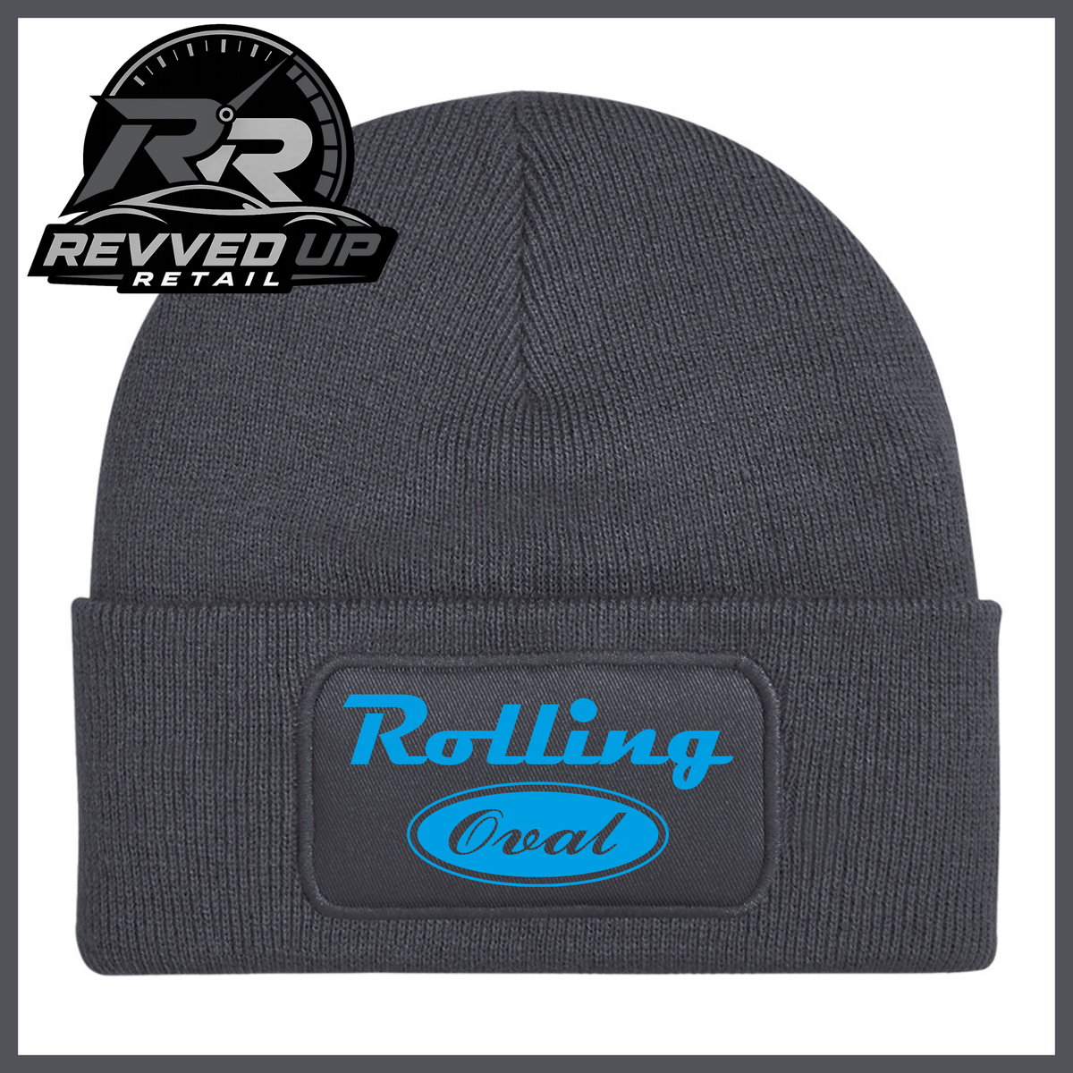 A dark grey ribbed knit beanie with a folded cuff featuring a black patch that reads 'Rolling Oval' in light blue. A Revved Up Retail logo is visible in the top-left corner.