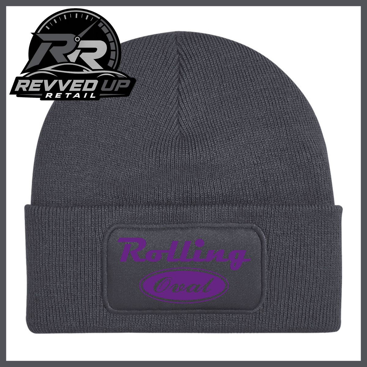 A dark grey ribbed knit beanie with a folded cuff featuring a black patch that reads 'Rolling Oval' in purple. A Revved Up Retail logo is visible in the top-left corner.