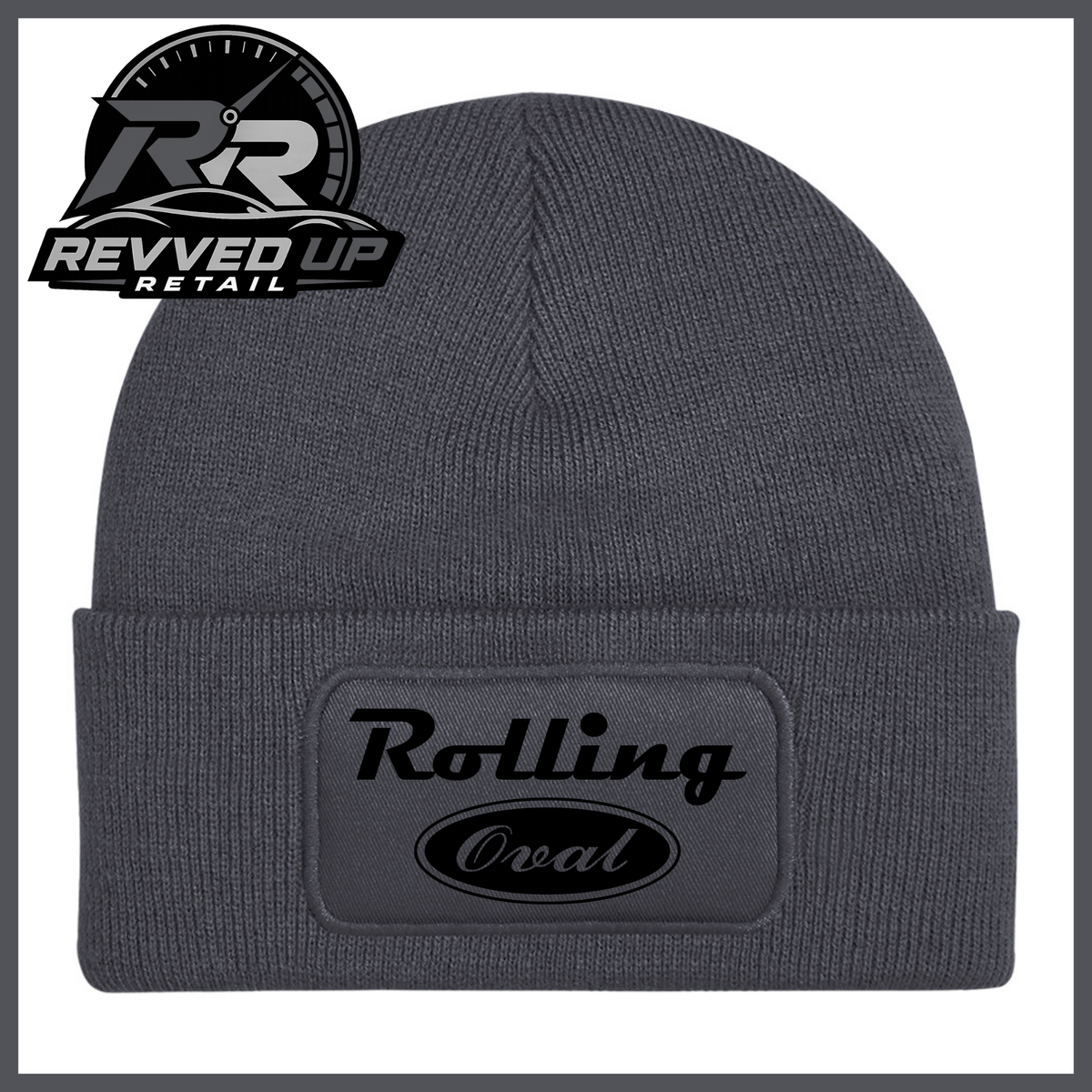 A dark grey ribbed knit beanie with a folded cuff featuring a black patch that reads 'Rolling Oval' in black. A Revved Up Retail logo is visible in the top-left corner.