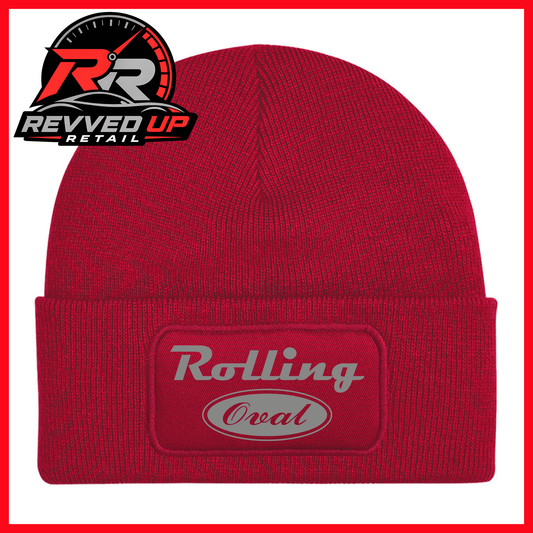 A red ribbed knit beanie with a cuffed brim featuring an oval patch that reads 'Rolling Oval' in grey. A Revved Up Retail logo is visible in the top-left corner.