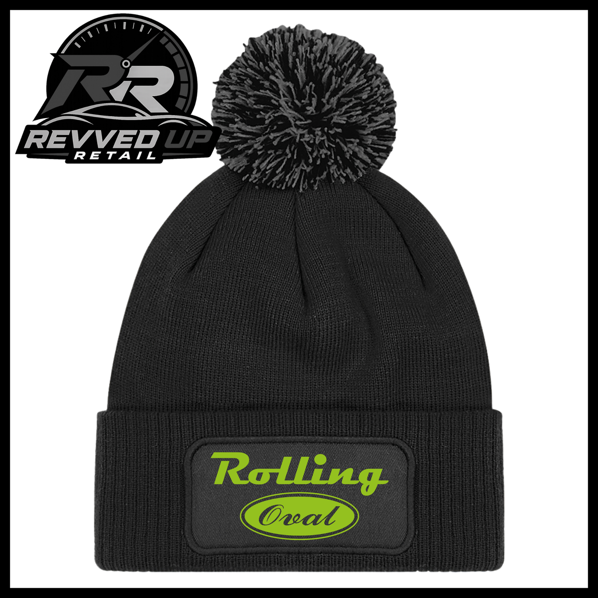A black ribbed knit pom-pom beanie with a folded cuff featuring an oval black patch with green text reading 'Rolling Oval'. A Revved Up Retail logo is visible in the top-left corner.