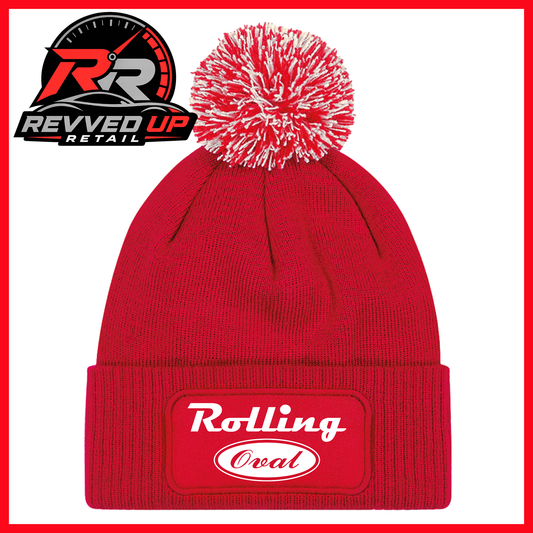 A red knit beanie with a white and red pom-pom on top and a red cuffed front patch reading 'Rolling Oval' in white. A Revved Up Retail logo appears in the upper left corner.