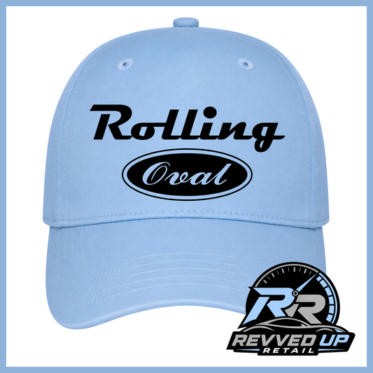 A light blue baseball cap with 'Rolling Oval' on the front in black and white background. A Revved Up Retail logo is overlaid in the bottom right corner.