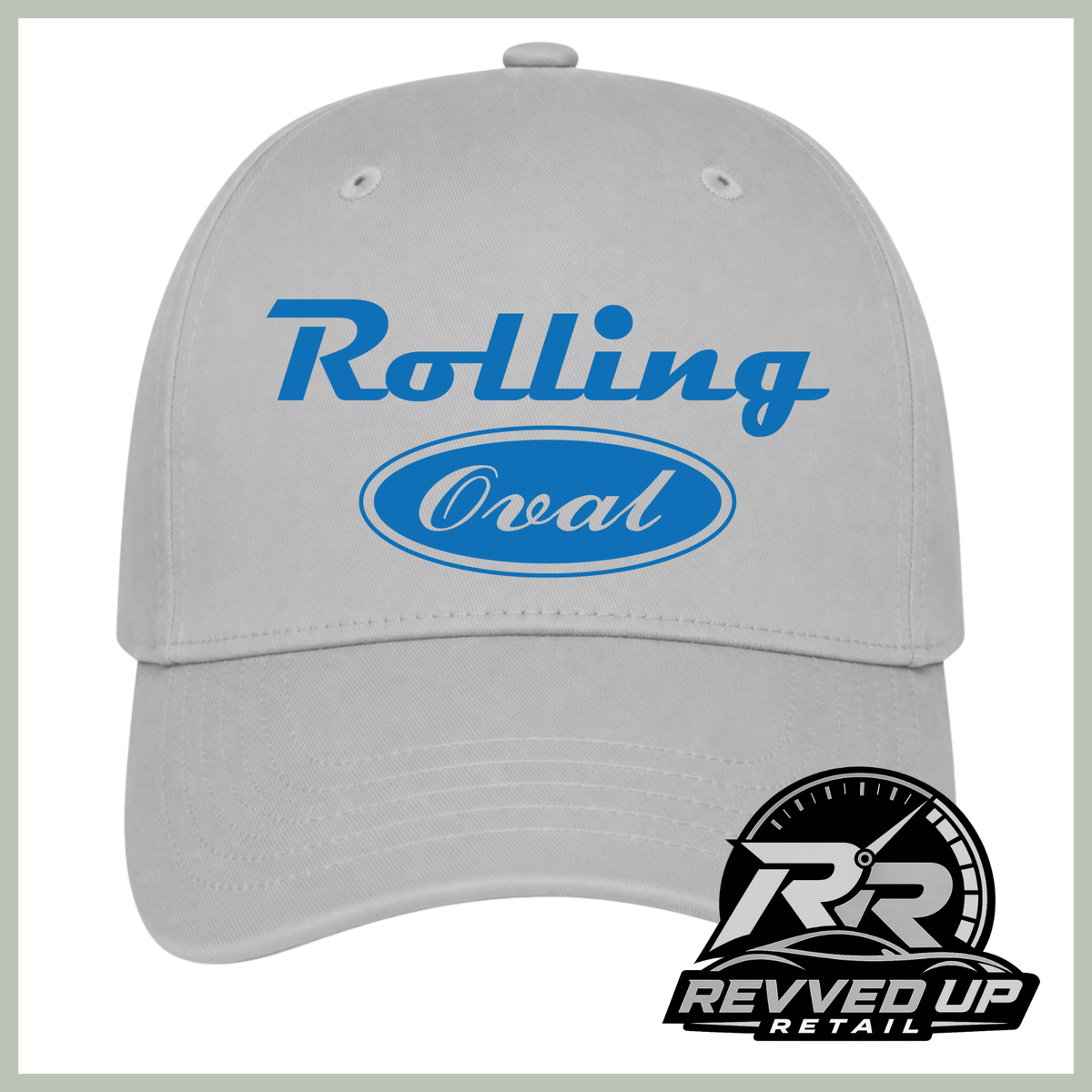 A light gray baseball cap with blue text reading 'Rolling Oval' on the front, plus a Revved Up Retail logo badge in the lower right corner.