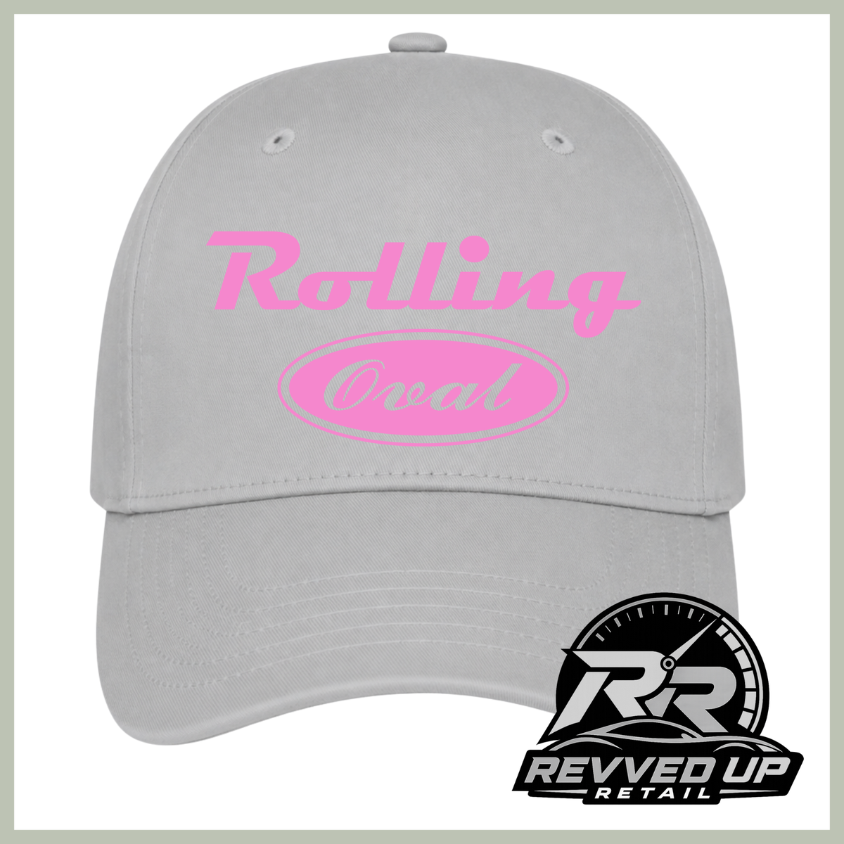 A light gray baseball cap with pink text reading 'Rolling Oval' on the front, shown on a white background with a Revved Up Retail logo in the bottom right corner.