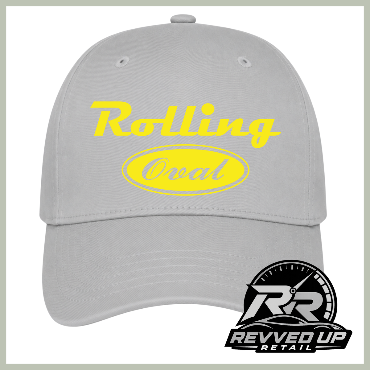 A light gray baseball cap with yellow text reading 'Rolling Oval' on the front, shown on a white background with a Revved Up Retail logo in the bottom right corner.