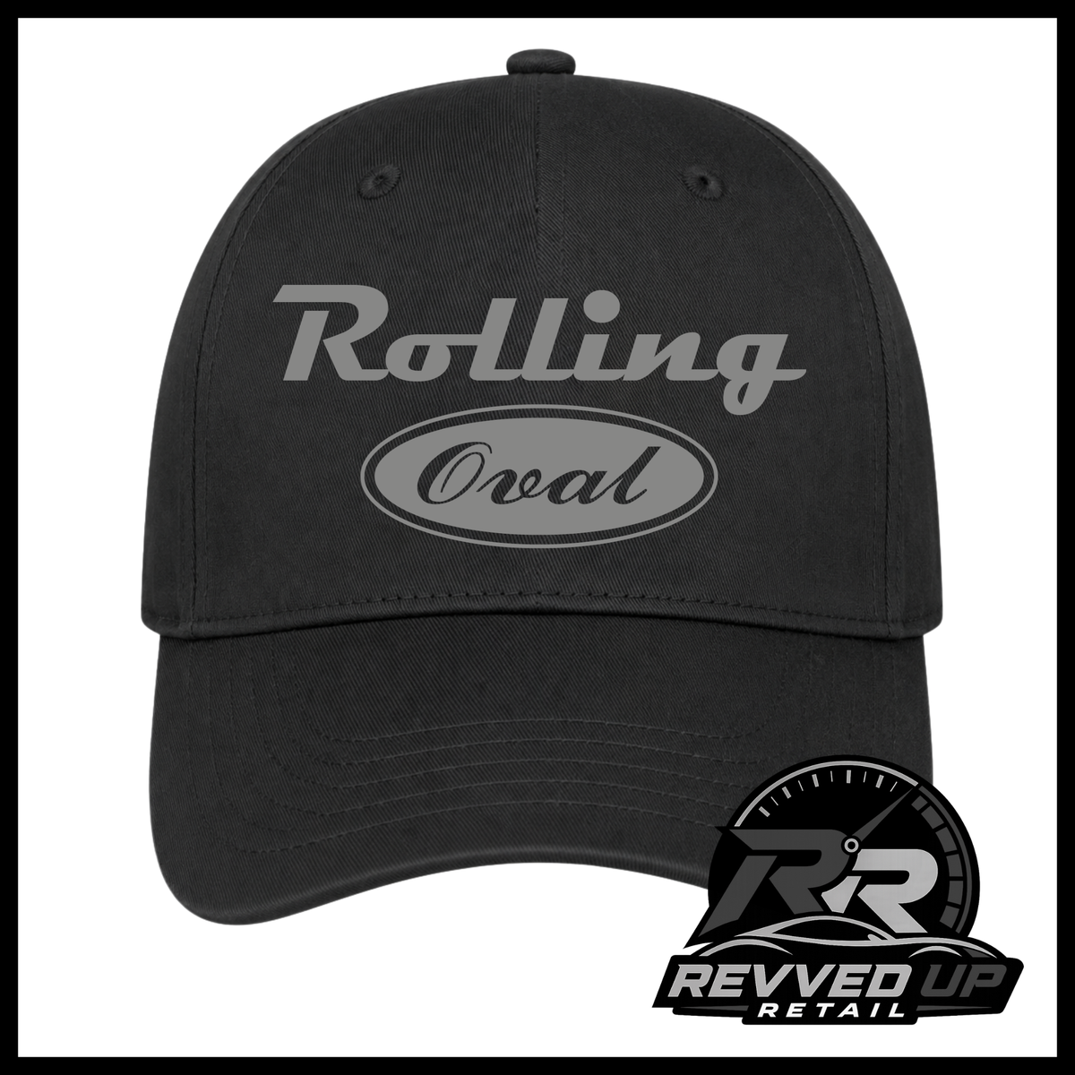 A black baseball cap featuring a grey 'Rolling Oval' logo on the front. The image is framed with a black border, and a 'Revved Up Retail' logo watermark is visible in the bottom right corner.