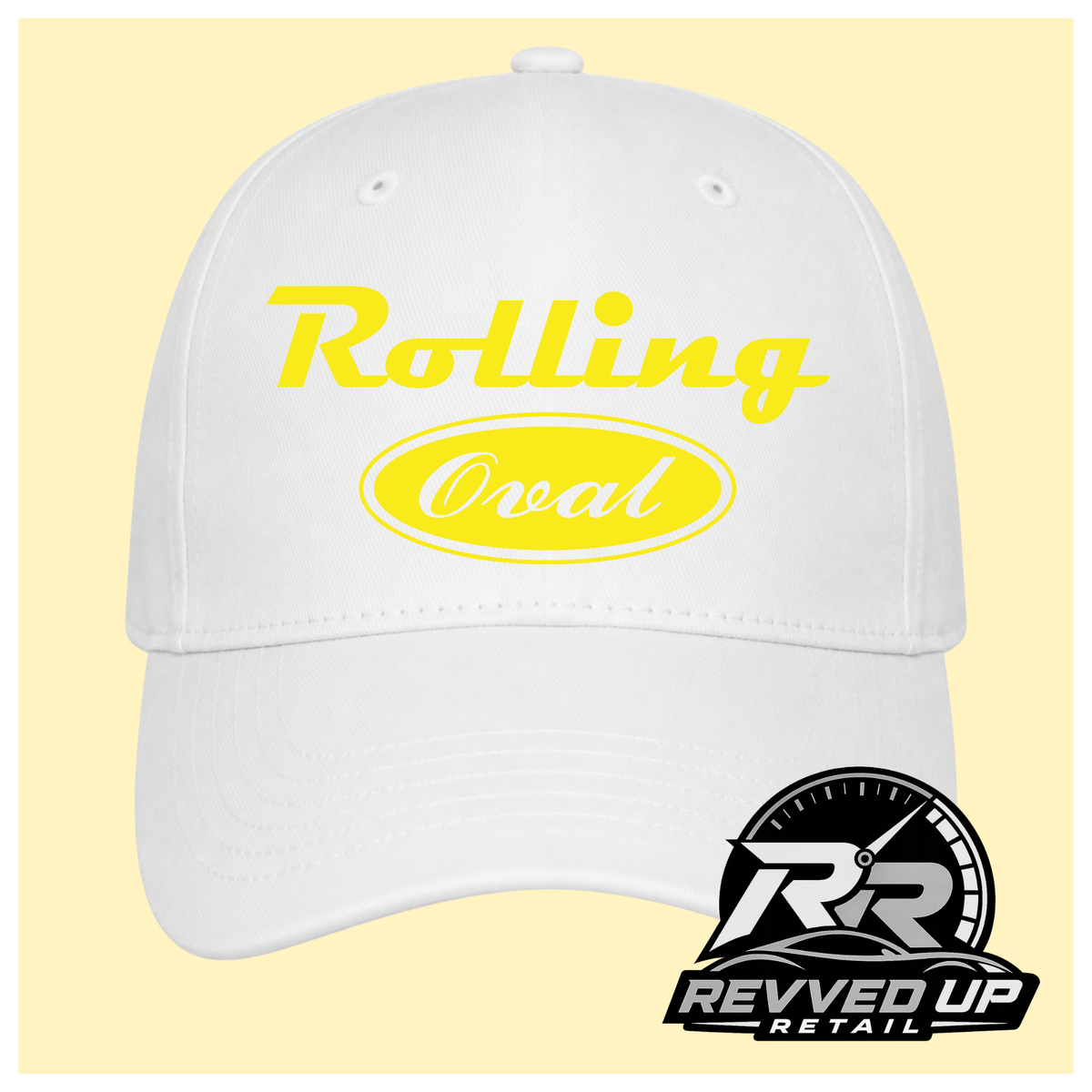A white baseball cap with yellow text reading 'Rolling Oval' on the front, shown against a pale yellow background. A Revved Up Retail logo watermark is visible in the bottom right corner.