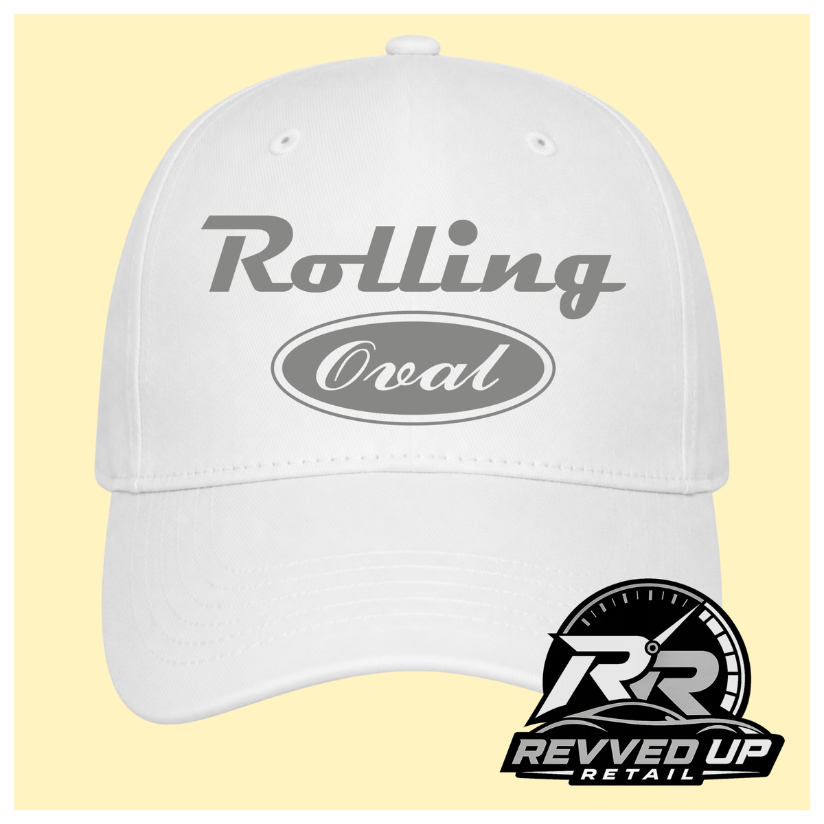 A white baseball cap with grey text reading 'Rolling Oval' on the front, shown against a pale yellow background. A Revved Up Retail logo watermark is visible in the bottom right corner.