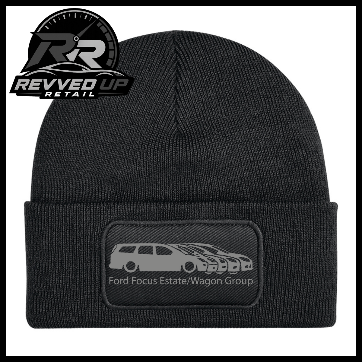 A black ribbed knit beanie with a folded cuff, featuring a black rectangular patch with a grey car graphic and the text 'Ford Focus Estate/Wagon Group.' A Revved Up Retail logo appears in the top-left corner.