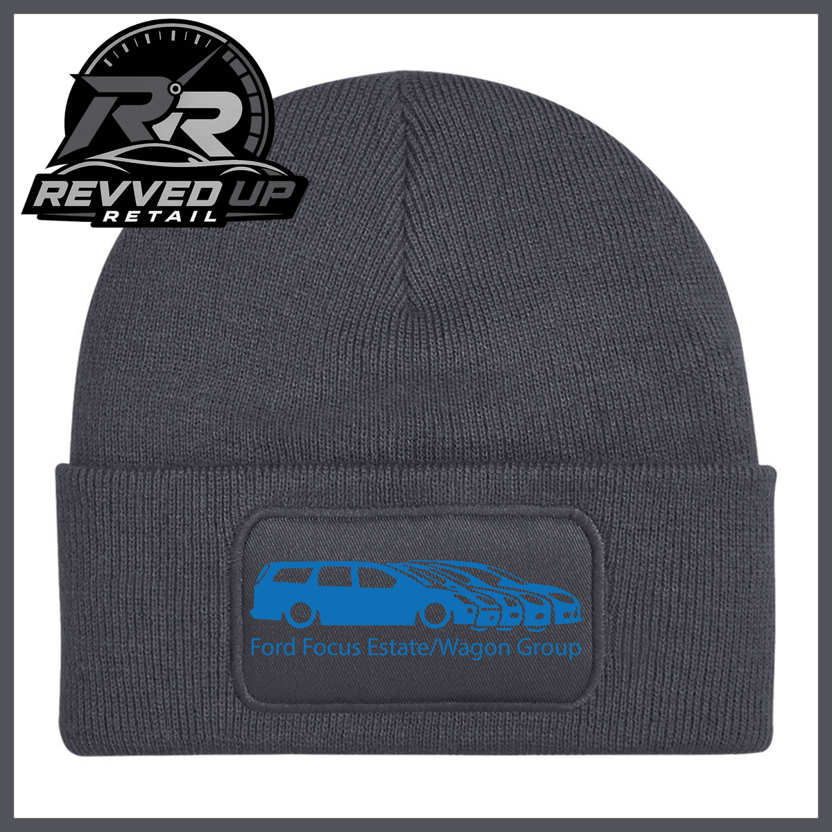 A grey ribbed knit beanie with a folded cuff, featuring a black rectangular patch with a blue car graphic and the text 'Ford Focus Estate/Wagon Group.' A Revved Up Retail logo appears in the top-left corner.