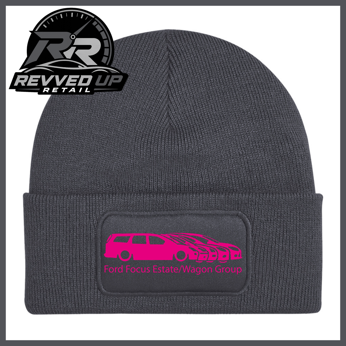 A grey ribbed knit beanie with a folded cuff, featuring a black rectangular patch with a hot pink car graphic and the text 'Ford Focus Estate/Wagon Group.' A Revved Up Retail logo appears in the top-left corner.