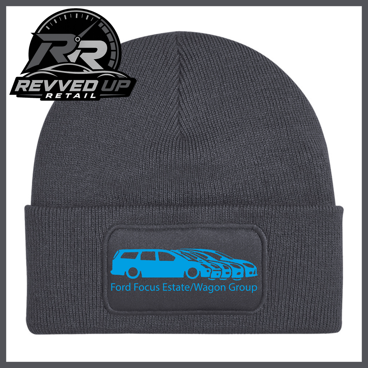A grey ribbed knit beanie with a folded cuff, featuring a black rectangular patch with a light blue car graphic and the text 'Ford Focus Estate/Wagon Group.' A Revved Up Retail logo appears in the top-left corner.