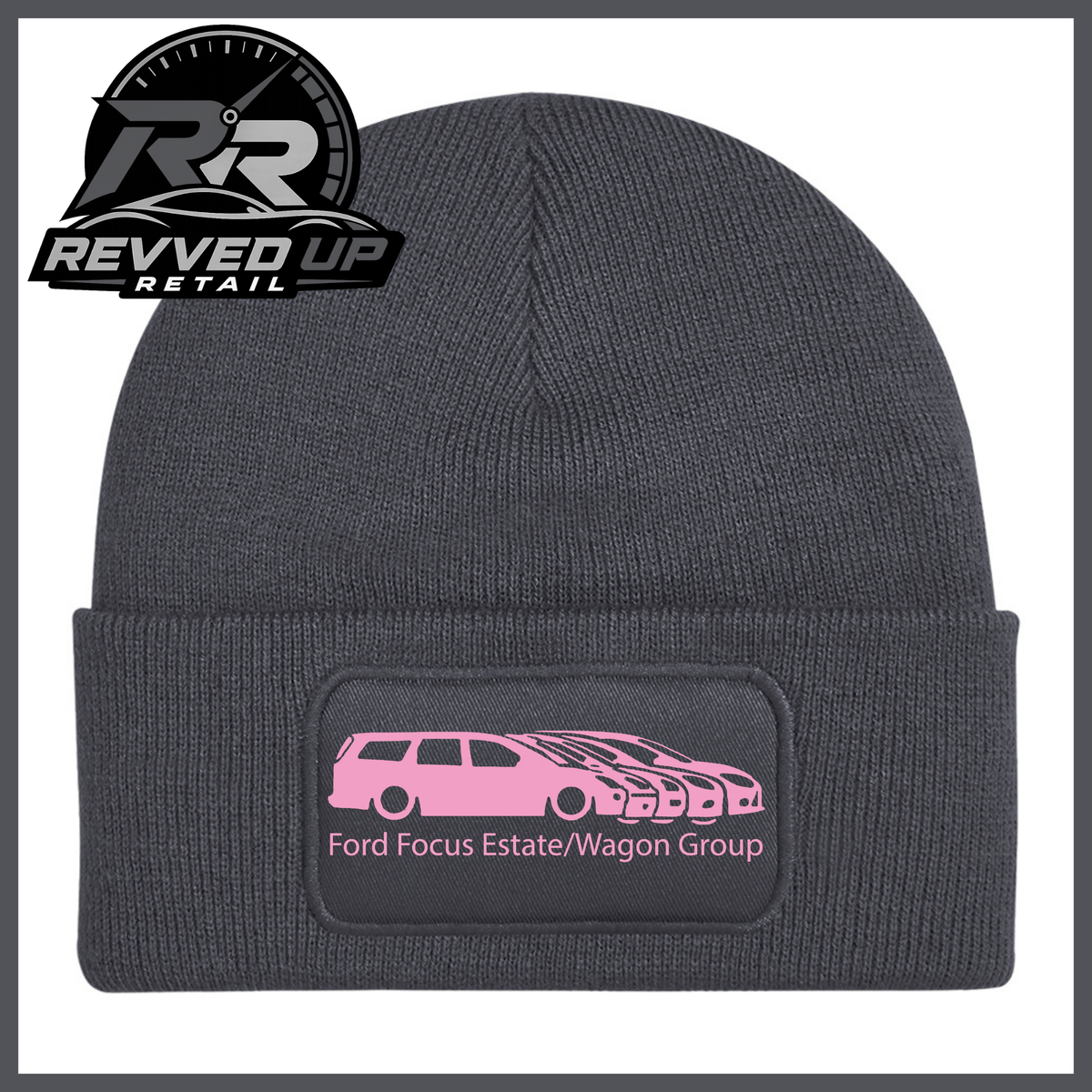 A grey ribbed knit beanie with a folded cuff, featuring a black rectangular patch with a pale pink car graphic and the text 'Ford Focus Estate/Wagon Group.' A Revved Up Retail logo appears in the top-left corner.