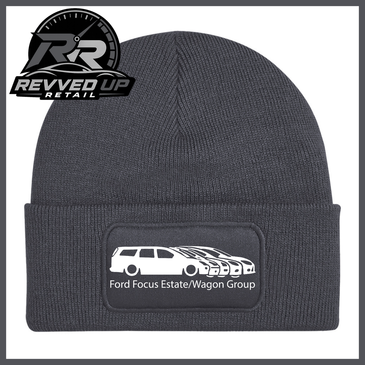 A grey ribbed knit beanie with a folded cuff, featuring a black rectangular patch with a white car graphic and the text 'Ford Focus Estate/Wagon Group.' A Revved Up Retail logo appears in the top-left corner.