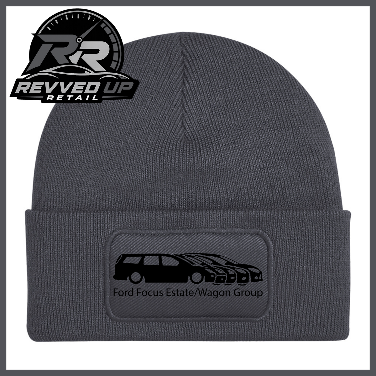 A grey ribbed knit beanie with a folded cuff, featuring a black rectangular patch with a black car graphic and the text 'Ford Focus Estate/Wagon Group.' A Revved Up Retail logo appears in the top-left corner.