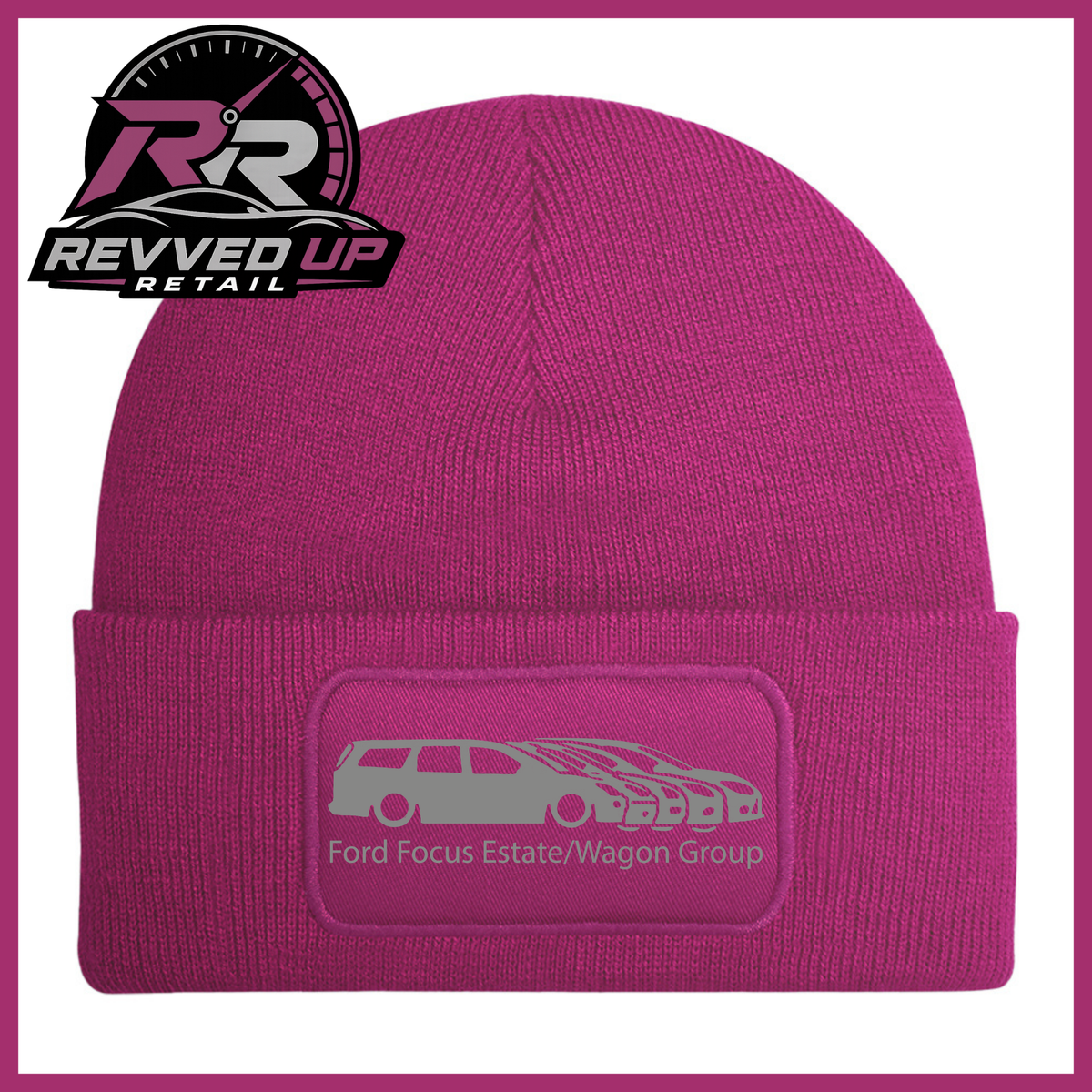 A fuchsia knit beanie with a folded cuff featuring a rectangular patch that reads 'Ford Focus Estate/Wagon Group' with a grey car graphic. The Revved Up Retail logo is displayed in the top-left corner.