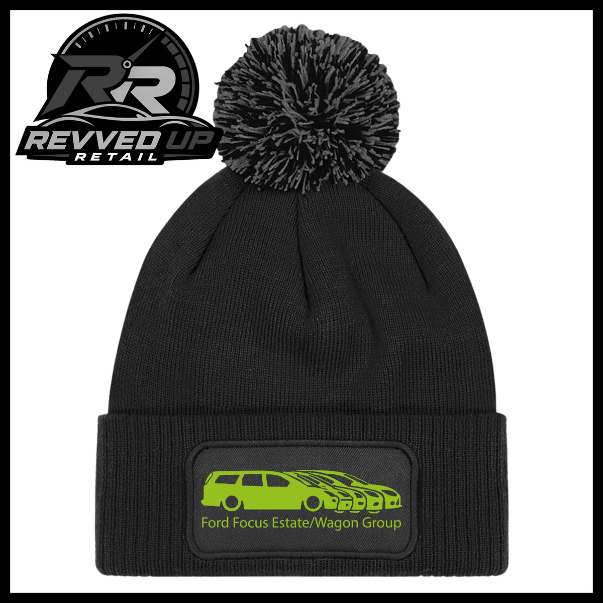 A black knit pom-pom beanie with a folded cuff featuring a black patch with a green car graphic and the text 'Ford Focus Estate/Wagon Group'. A Revved Up Retail logo is visible in the top-left corner.