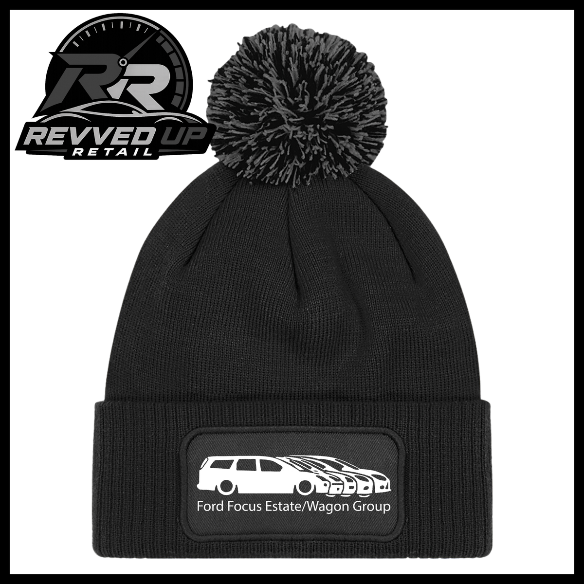 A black knit pom-pom beanie with a folded cuff featuring a black patch with a white car graphic and the text 'Ford Focus Estate/Wagon Group'. A Revved Up Retail logo is visible in the top-left corner.