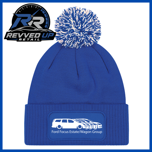 A royal blue knit beanie with a white and blue pom-pom and a custom patch on the cuff. The patch features a white car outline and the text 'Ford Focus Estate/Wagon Group'.