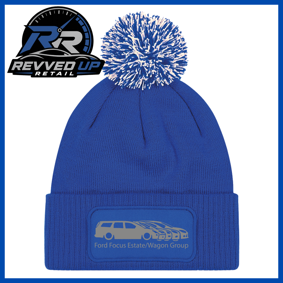 A royal blue knit beanie with a matching blue and white pom-pom and a cuffed lower section featuring a debossed patch with a car graphic and the text 'Ford Focus Estate/Wagon Group.' A Revved Up Retail logo appears in the top-left corner.
