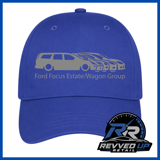 A royal blue baseball cap featuring a gray graphic of a Ford Focus estate and wagon with the text 'Ford Focus Estate/Wagon Group' on the front. A Revved Up Retail logo is displayed in the bottom right corner.