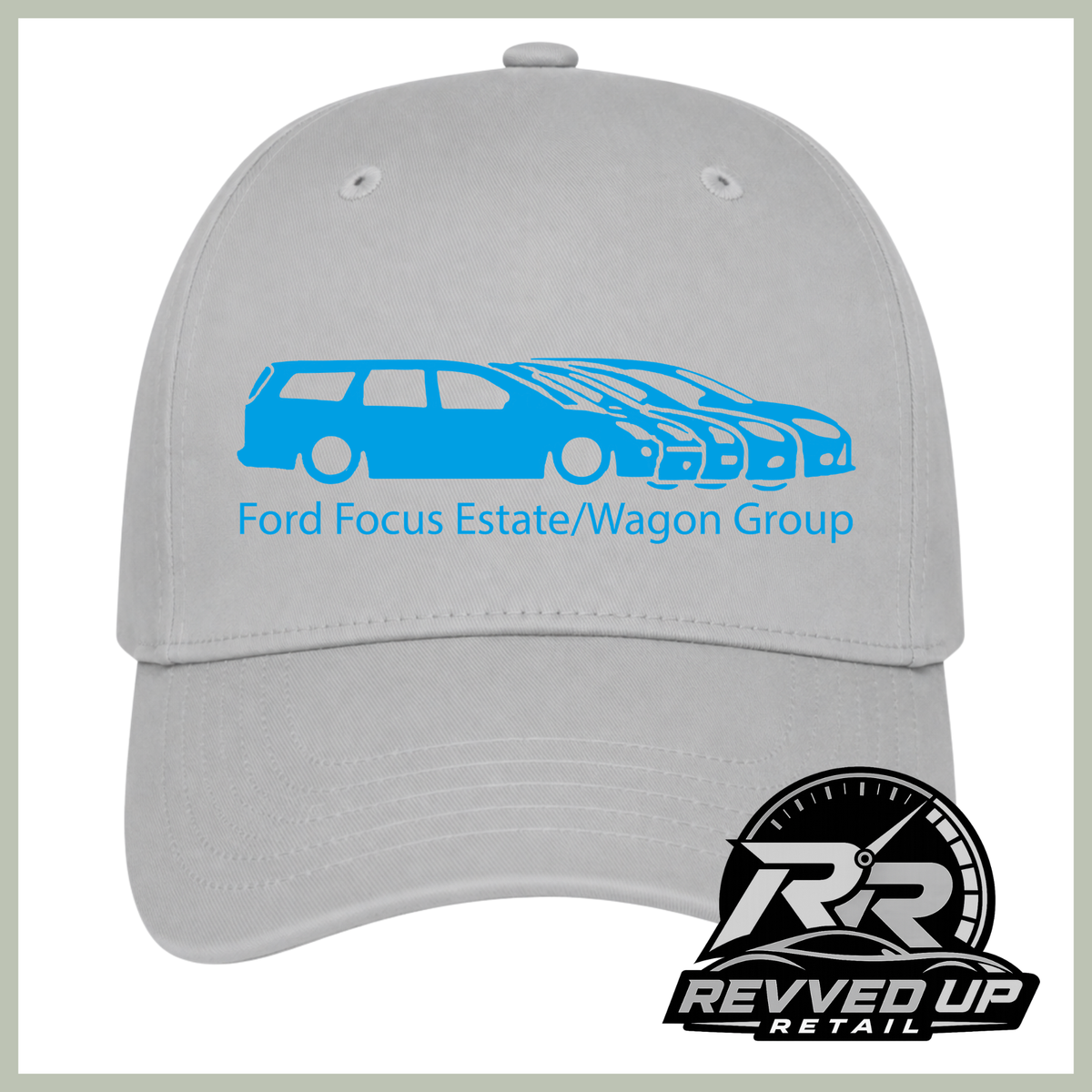 A light gray baseball cap featuring a blue graphic of a Ford Focus estate and wagon group with the text 'Ford Focus Estate/Wagon Group' on the front. A 'Revved Up Retail' logo is displayed in the bottom right corner.