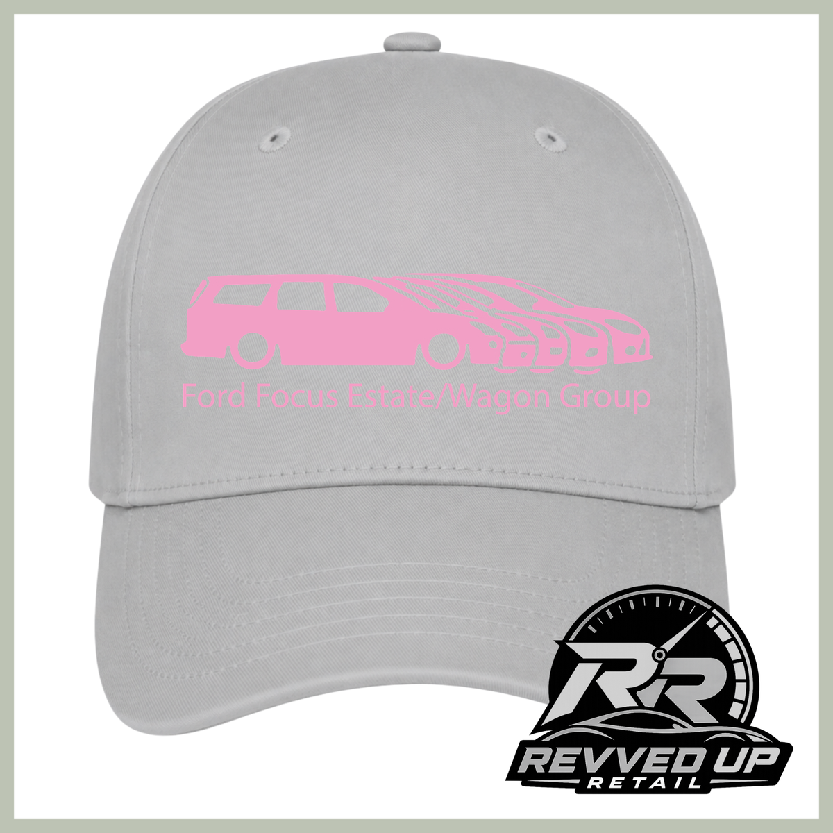 A light gray baseball cap featuring a pink graphic of a Ford Focus estate/wagon group with the text 'Ford Focus Estate/Wagon Group' on the front. A Revved Up Retail logo is visible in the bottom right corner.