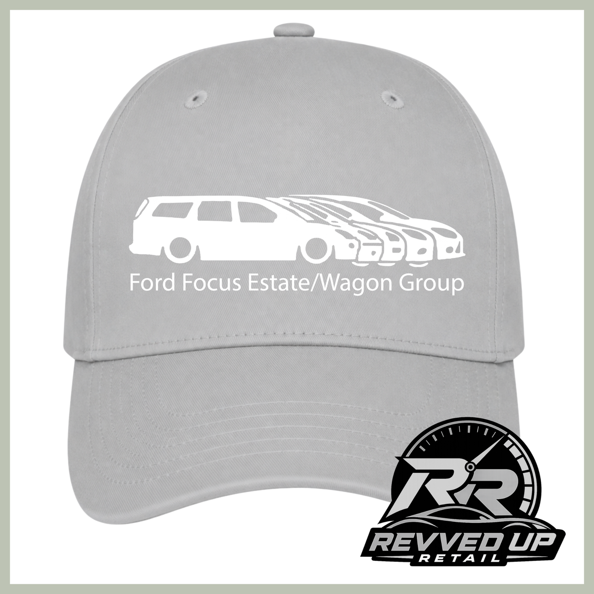 A light gray baseball cap featuring a white graphic of a Ford Focus estate/wagon group with the text 'Ford Focus Estate/Wagon Group' on the front. A Revved Up Retail logo is visible in the bottom right corner.
