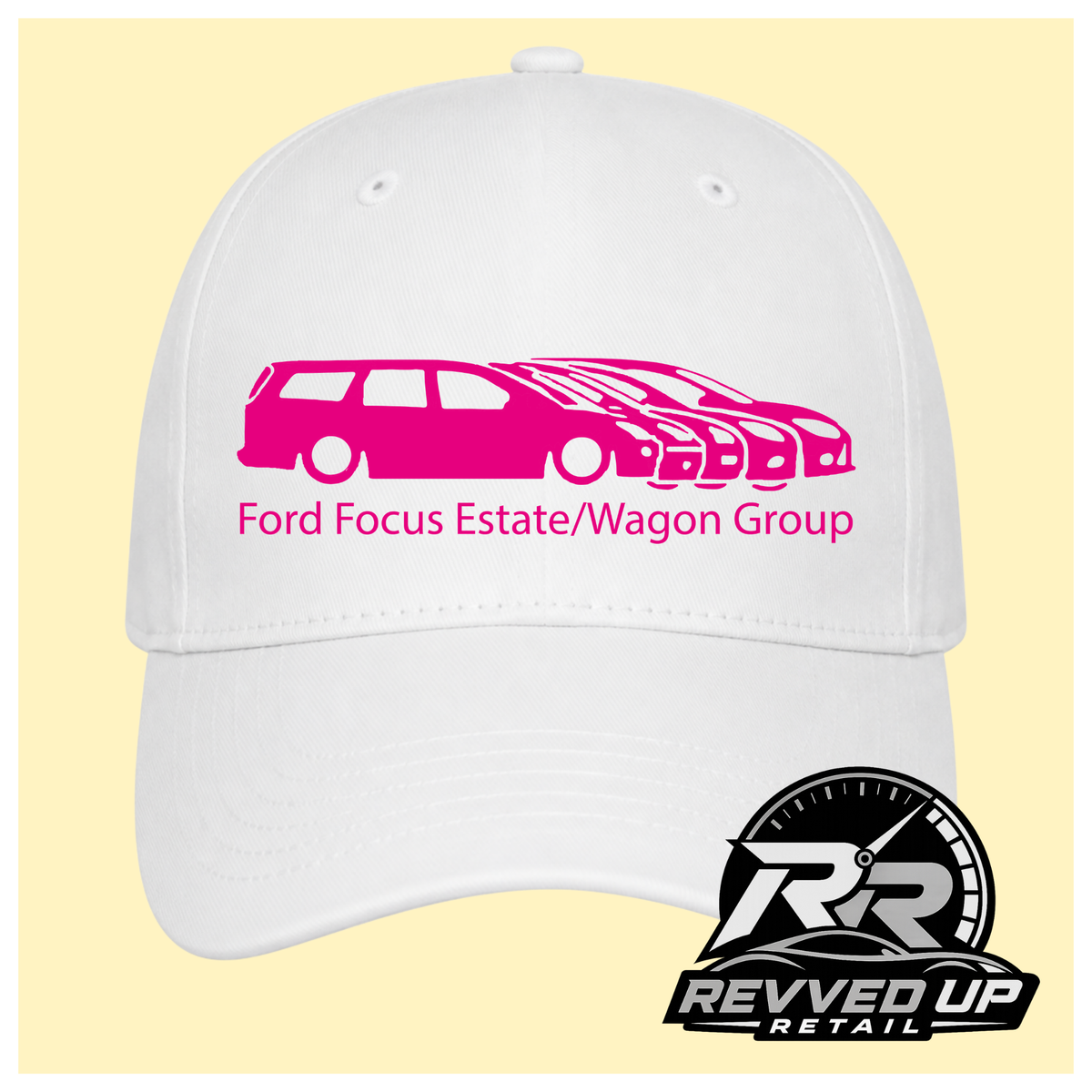 A white baseball cap with a hot pink graphic of multiple Ford Focus cars and the text 'Ford Focus Estate/Wagon Group' on the front, shown against a pale yellow background. A Revved Up Retail logo is visible in the bottom right corner.