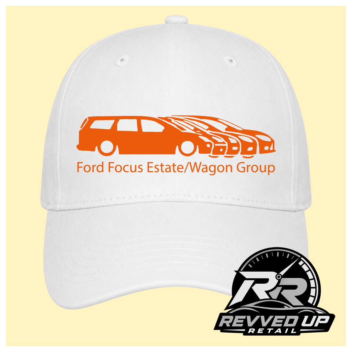 A white baseball cap with a orange graphic of multiple Ford Focus cars and the text 'Ford Focus Estate/Wagon Group' on the front, shown against a pale yellow background. A Revved Up Retail logo is visible in the bottom right corner.