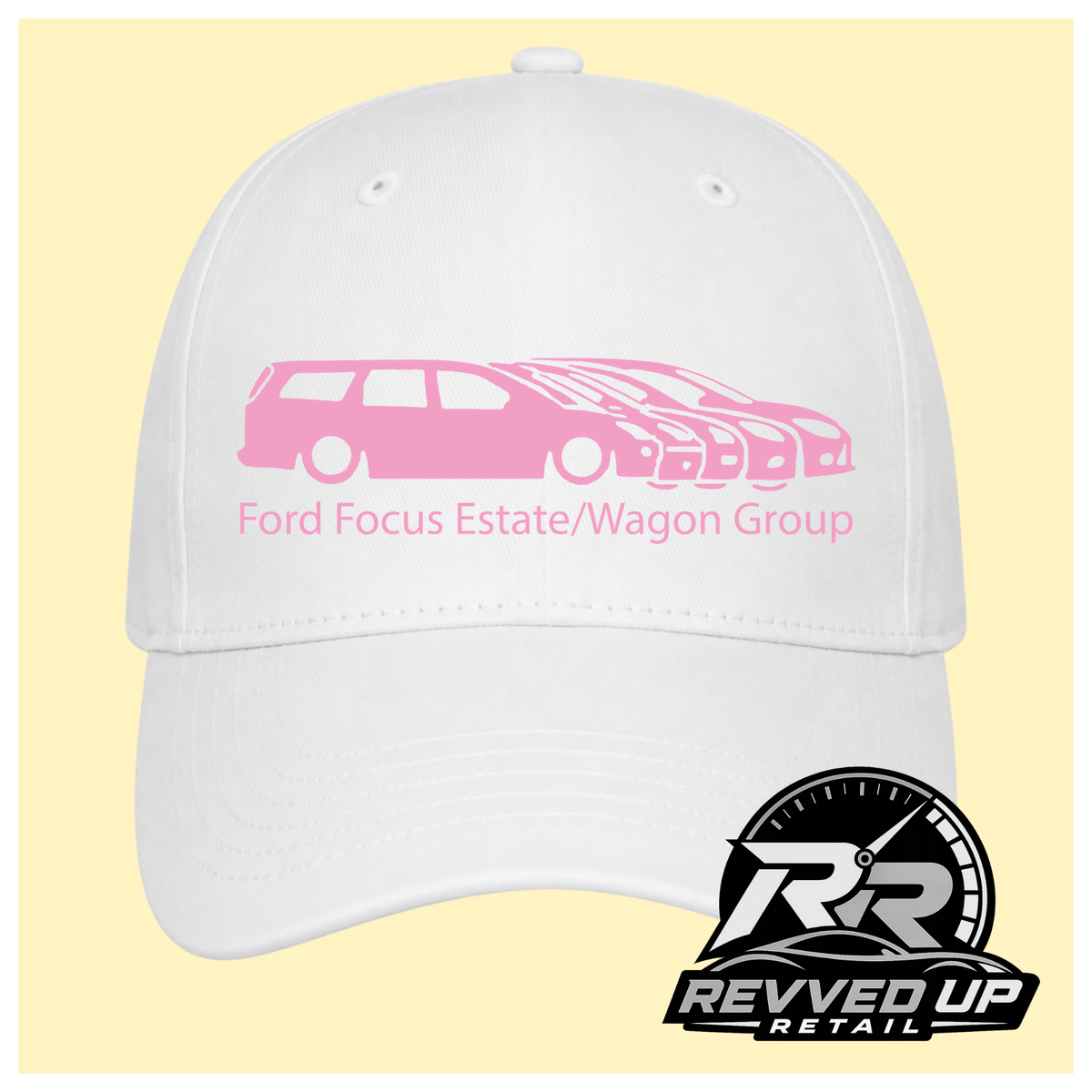 A white baseball cap with a pale pink graphic of multiple Ford Focus cars and the text 'Ford Focus Estate/Wagon Group' on the front, shown against a pale yellow background. A Revved Up Retail logo is visible in the bottom right corner.