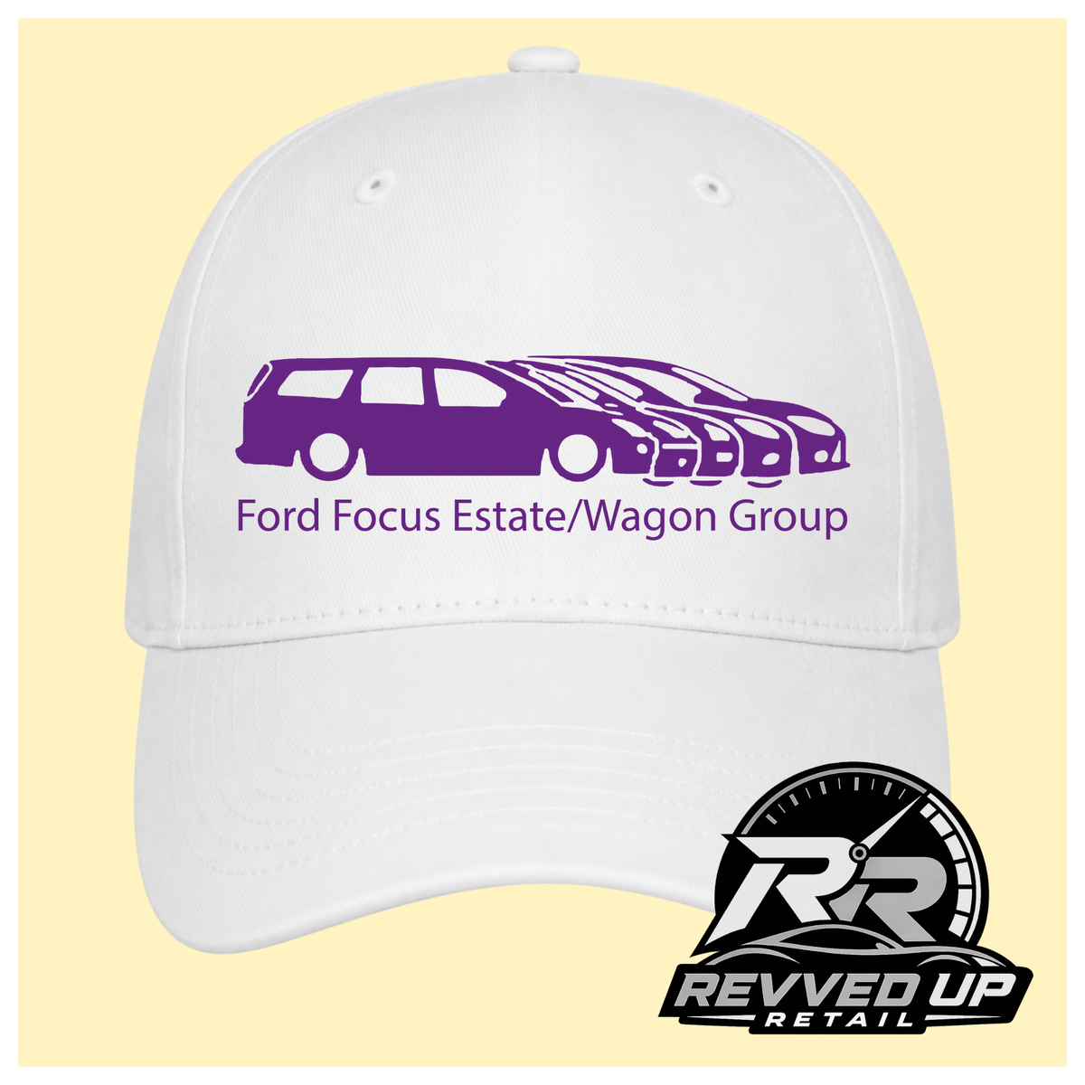 A white baseball cap with a purple graphic of multiple Ford Focus cars and the text 'Ford Focus Estate/Wagon Group' on the front, shown against a pale yellow background. A Revved Up Retail logo is visible in the bottom right corner.