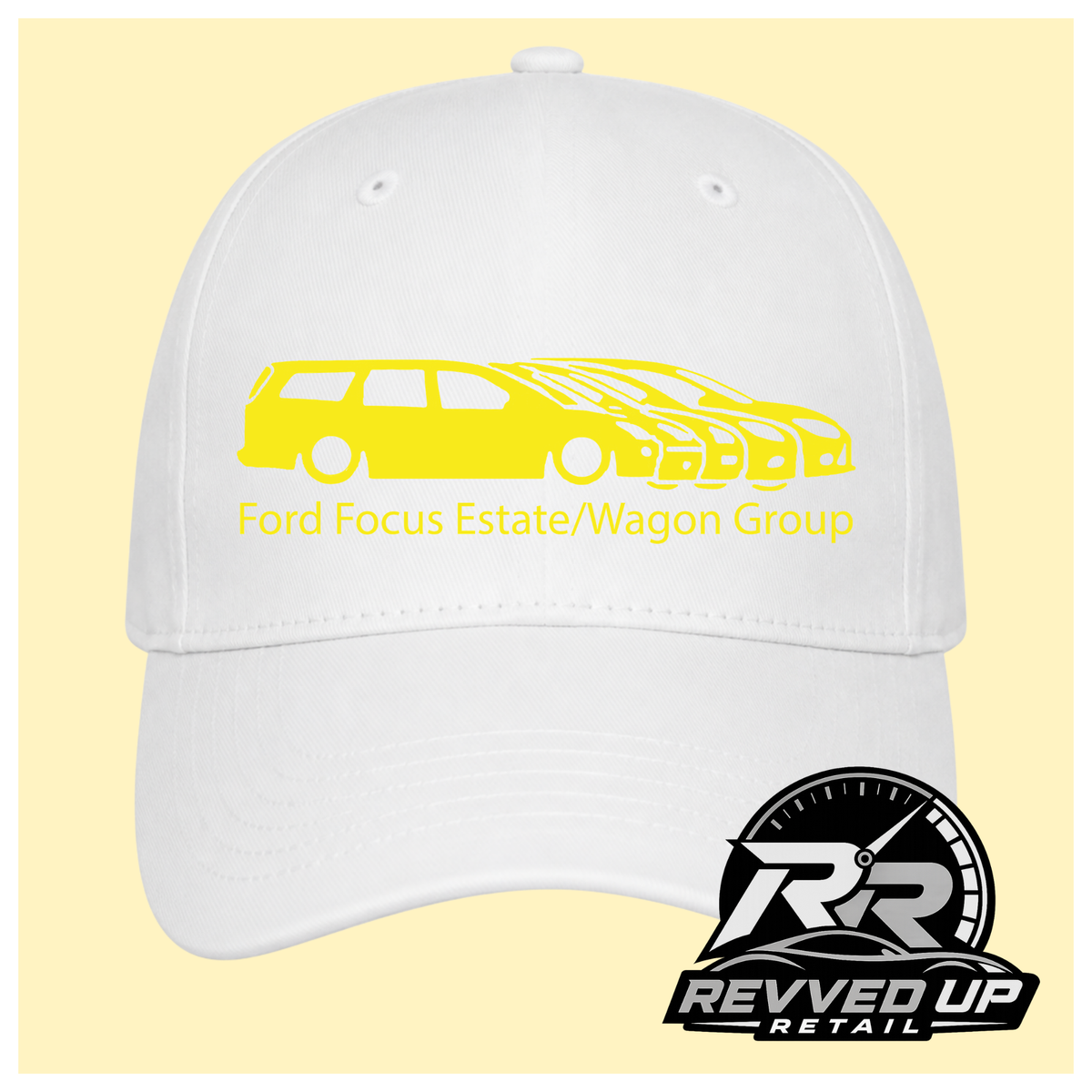A white baseball cap with a yellow graphic of multiple Ford Focus cars and the text 'Ford Focus Estate/Wagon Group' on the front, shown against a pale yellow background. A Revved Up Retail logo is visible in the bottom right corner.