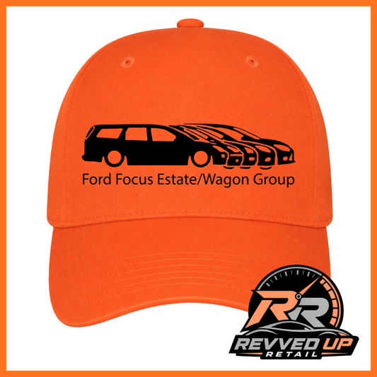 Bright orange baseball cap with a black graphic of a Ford Focus estate and wagon group, plus the text 'Ford Focus Estate/Wagon Group'. A Revved Up Retail logo is visible in the bottom right corner.