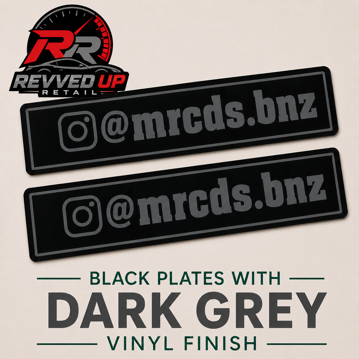 Two black rectangular vinyl decals with dark grey Instagram-style handles, shown on a light beige background with Revved Up Retail branding and text reading 'Black Plates with Dark Grey Vinyl Finish'.