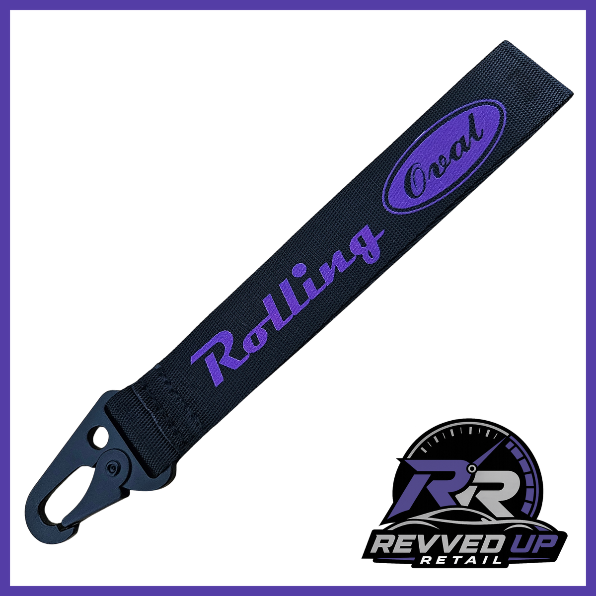 A Rolling Oval brand wristlet strap in black with purple printed logos and a black metal carabiner clip, shown on a white background with a Revved Up Retail watermark.