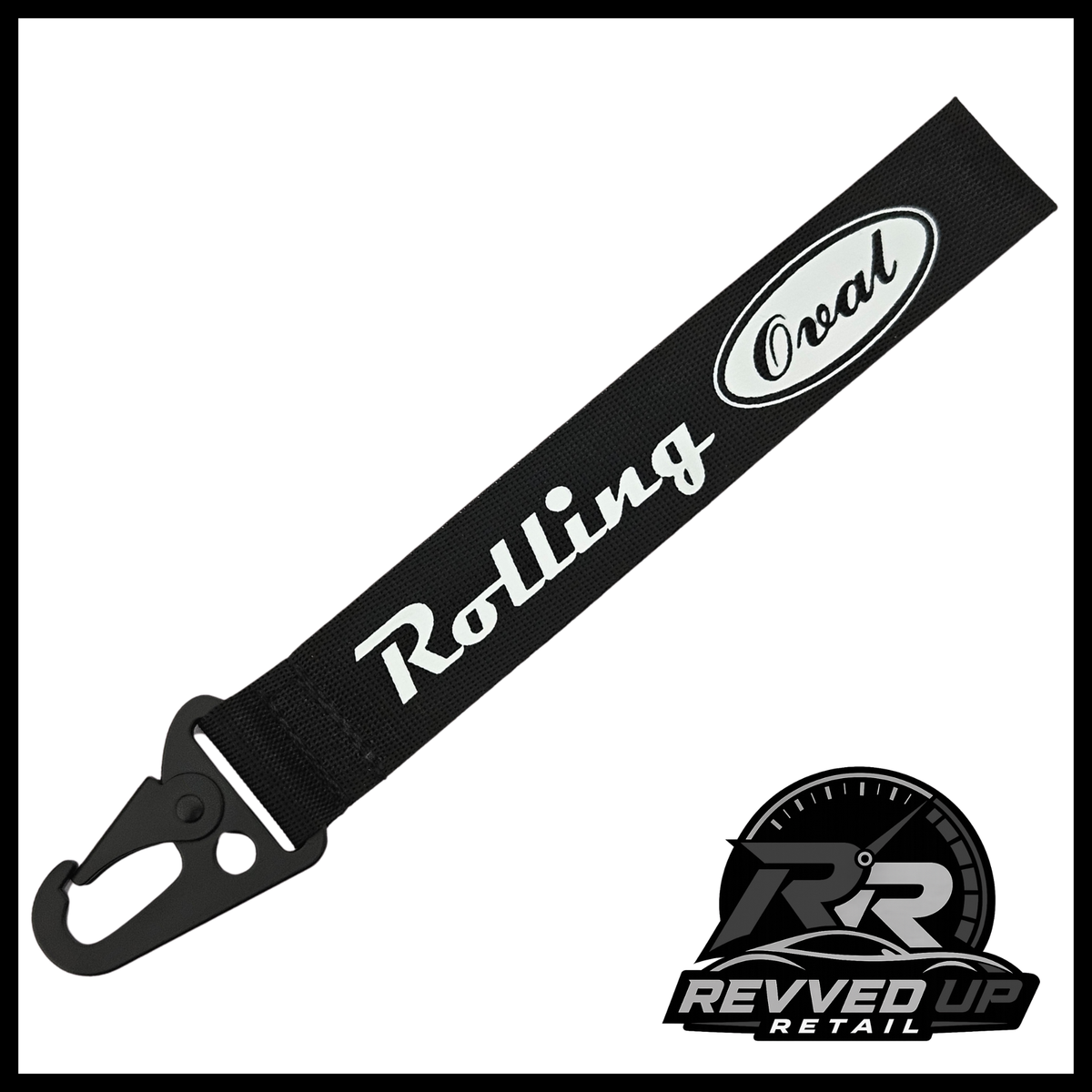 A Rolling Oval brand wristlet strap in black with white printed logos and a black metal carabiner clip, shown on a white background with a Revved Up Retail watermark.