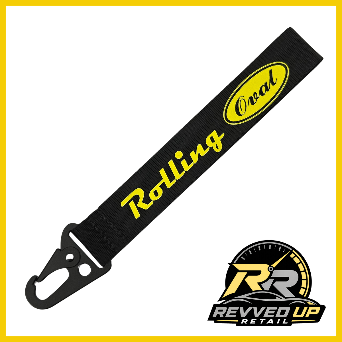 A Rolling Oval brand wristlet strap in black with yellow printed logos and a black metal carabiner clip, shown on a white background with a Revved Up Retail watermark.