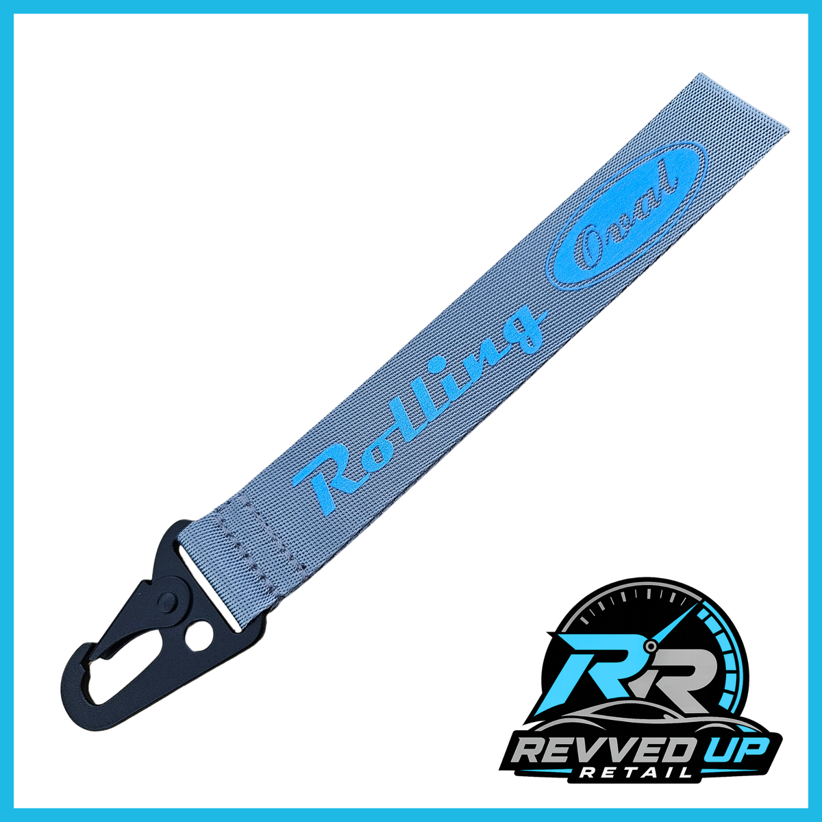 A Rolling Oval brand wristlet strap in grey with light blue printed logos and a black metal carabiner clip, shown on a white background with a Revved Up Retail watermark.